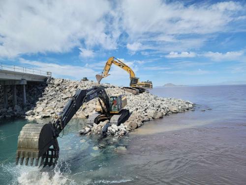 An excavator moves stones by the Great Salt Lake Causeway to raise the berm by 4 feet in July 2022. (Photo: Utah Division of Forestry, Fire and State Lands)